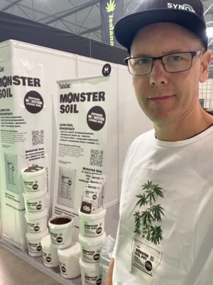 Monster Soil team member with Monster Soil Pots at a trade fair stand